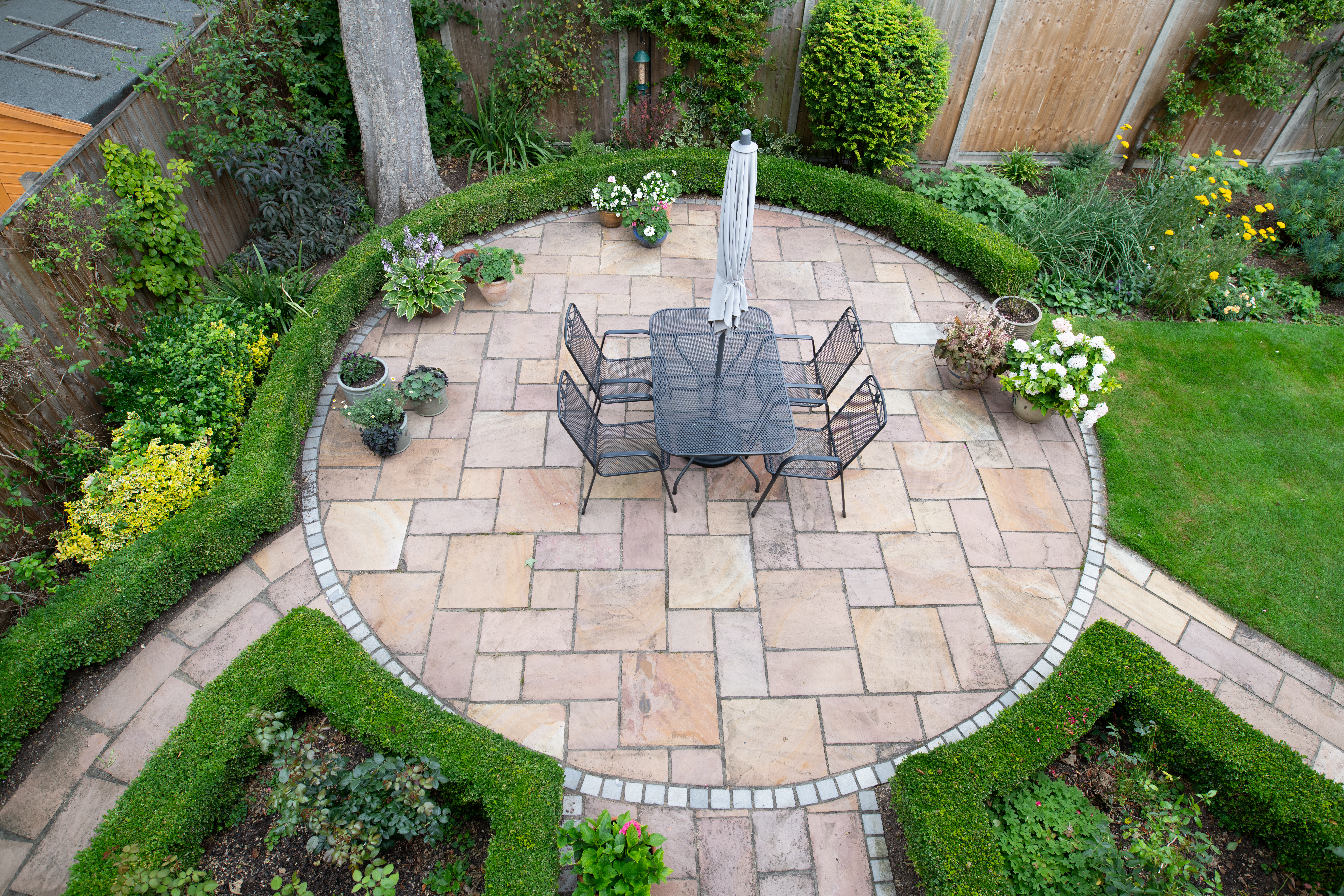 circular garden patio with freshly jet washed paving stones paver